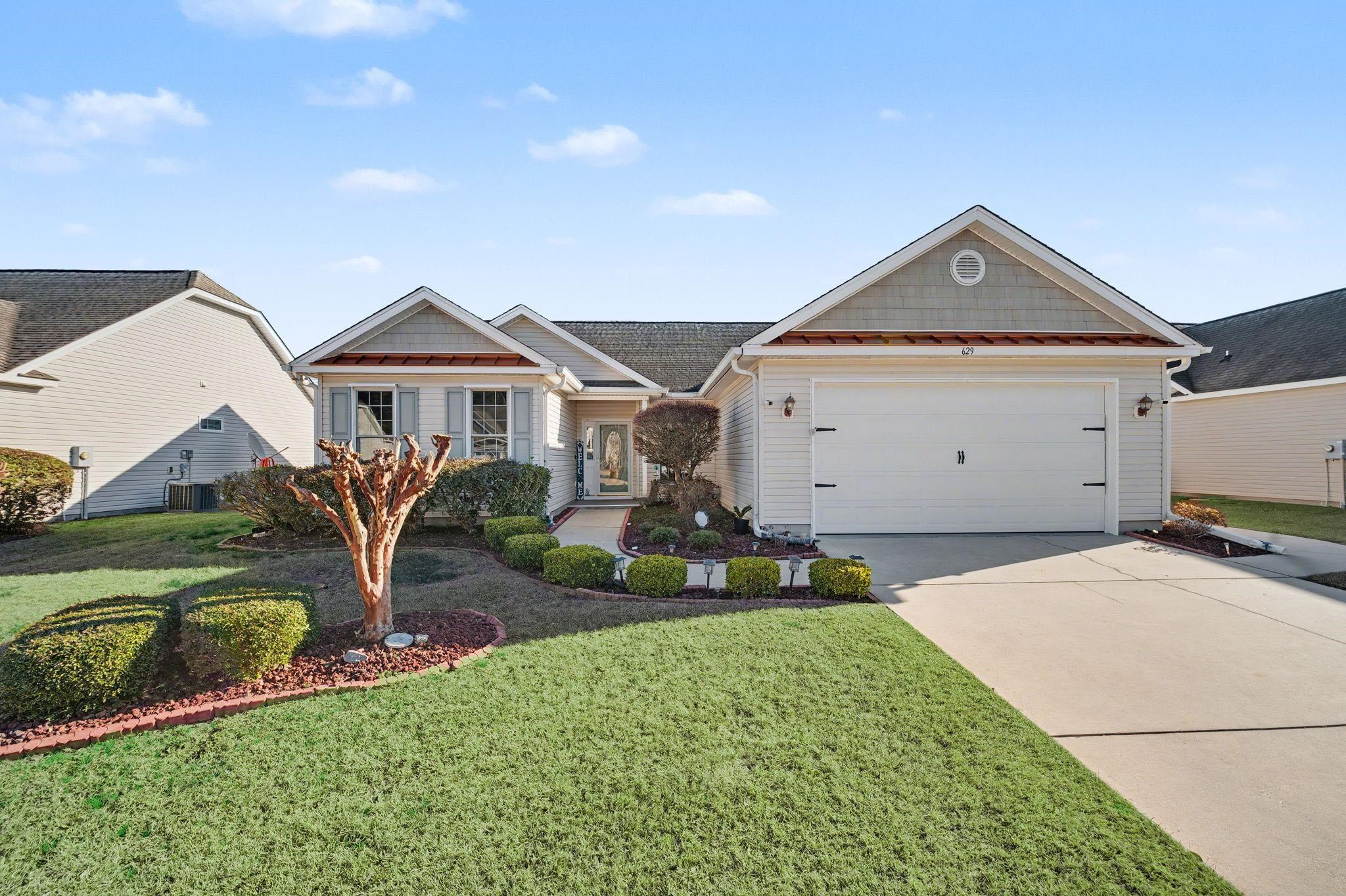 629 Cottontail Trail Myrtle Beach, SC 29588 - Photo 1 of 40 Craftsman-style home with driveway, a front yard, and a garage