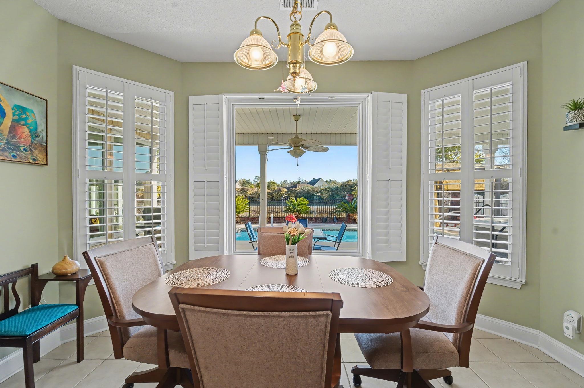 629 Cottontail Trail Myrtle Beach, SC 29588 - Photo 12 of 40 Dining room featuring light tile patterned floors and a chandelier