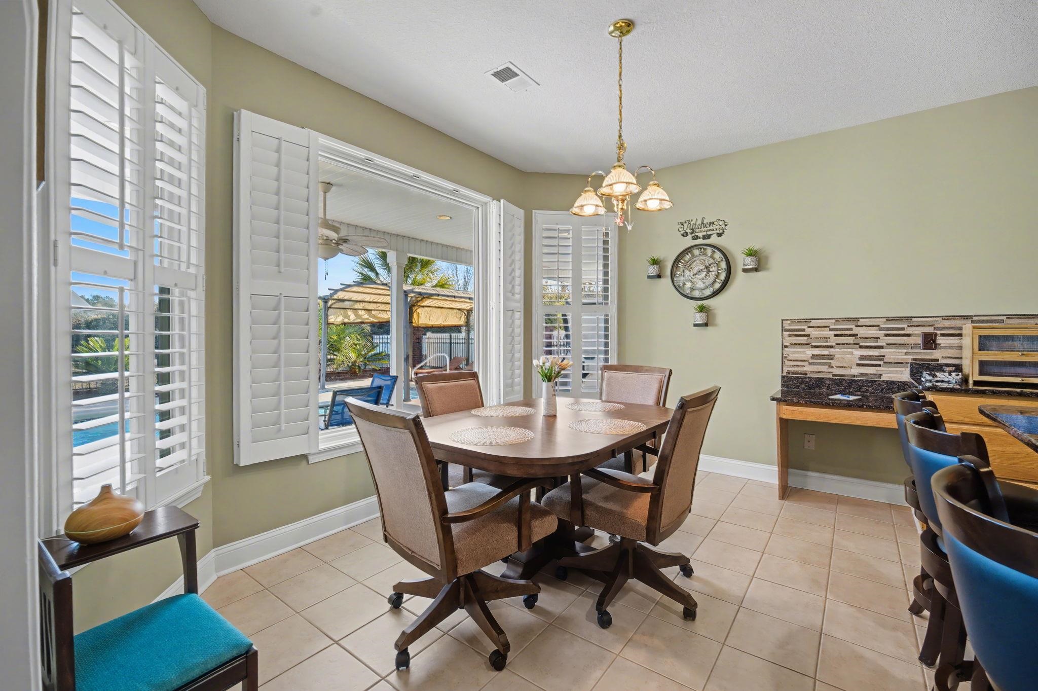 629 Cottontail Trail Myrtle Beach, SC 29588 - Photo 13 of 40 Dining area with light tile patterned floors and a chandelier