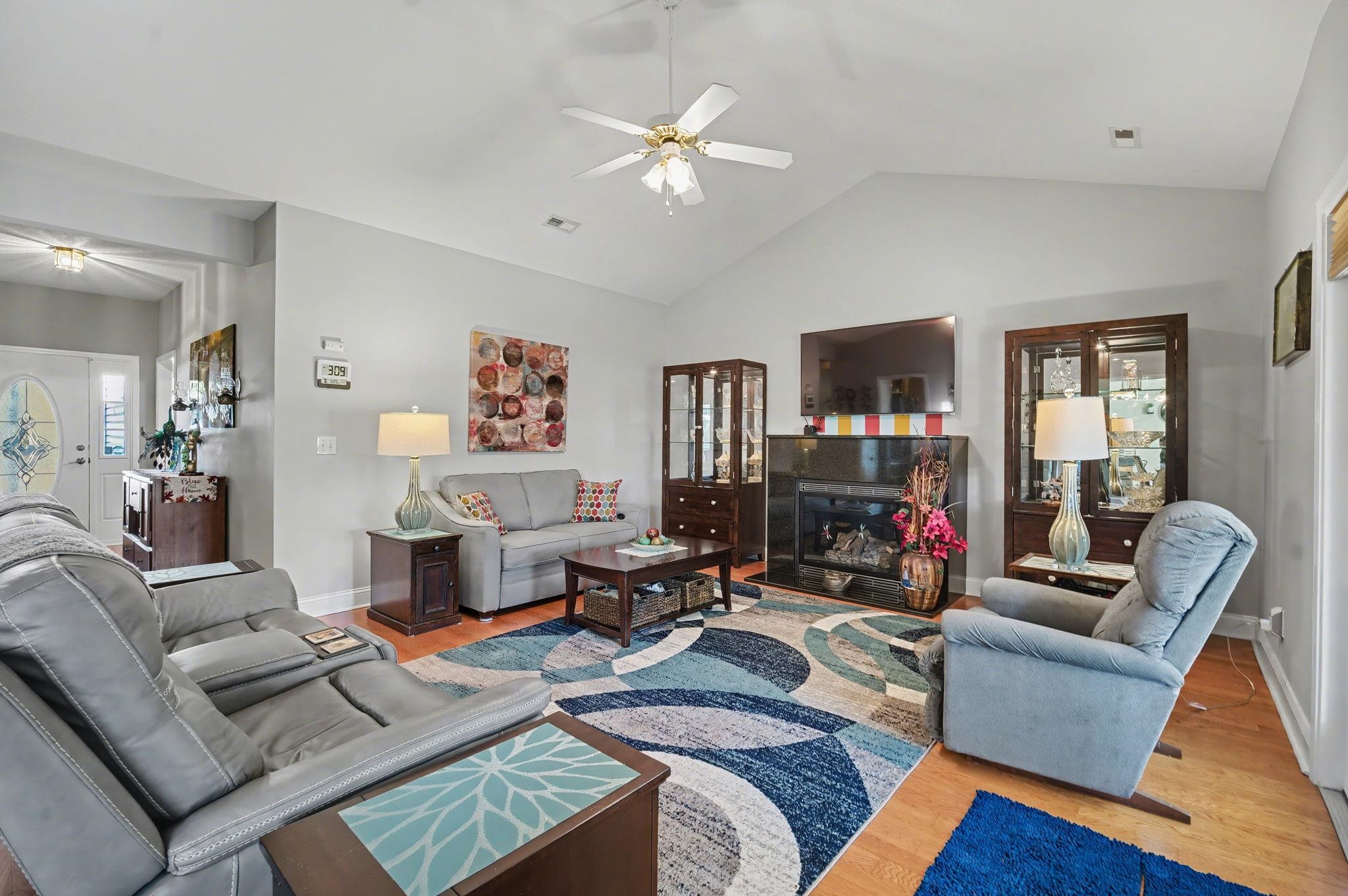 629 Cottontail Trail Myrtle Beach, SC 29588 - Photo 14 of 40 Living area with wood finished floors, a glass covered fireplace, ceiling fan, and high vaulted ceiling