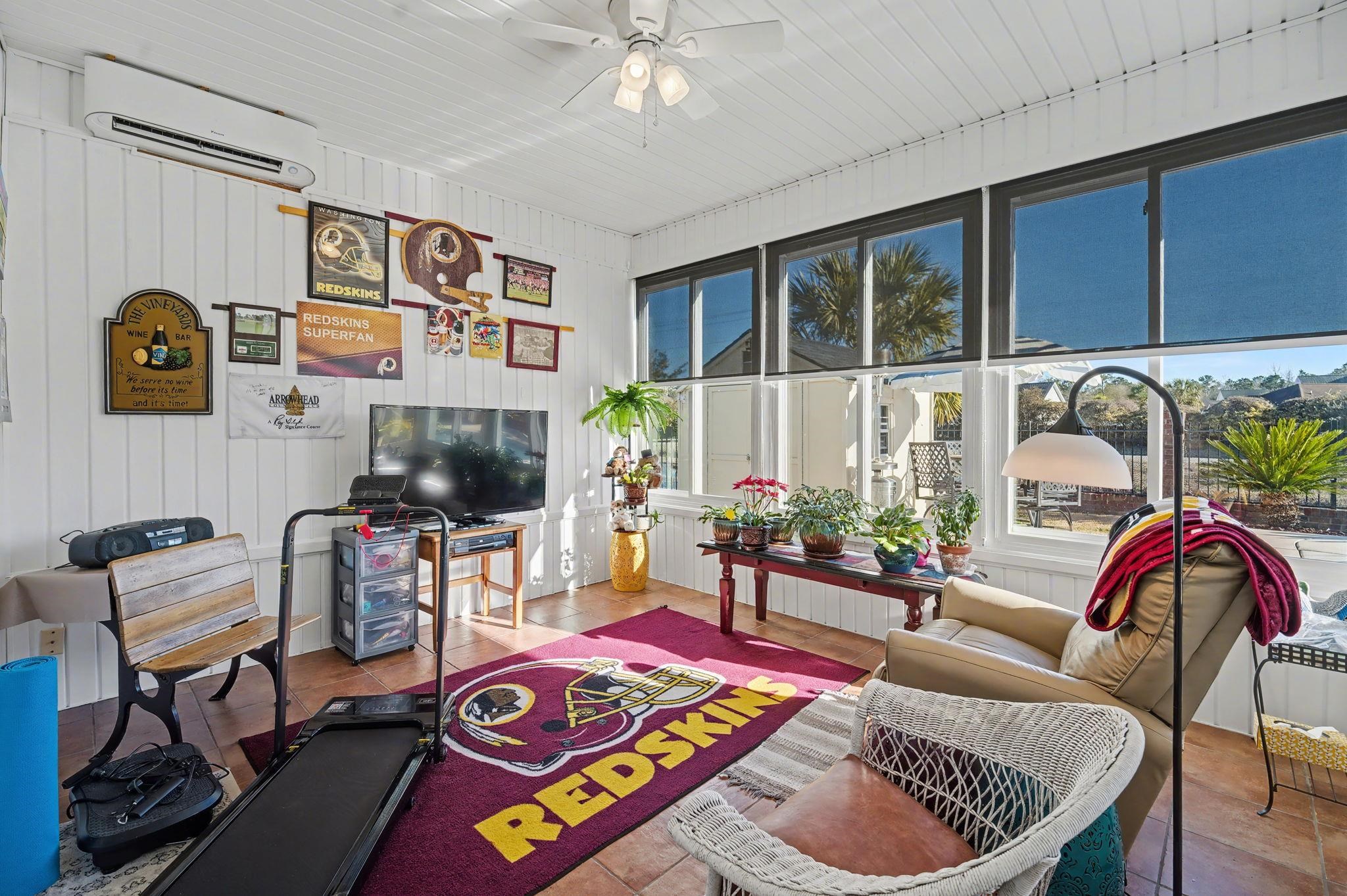 629 Cottontail Trail Myrtle Beach, SC 29588 - Photo 17 of 40 Sunroom / solarium featuring an AC wall unit, healthy amount of natural light, tile patterned floors, and wooden walls