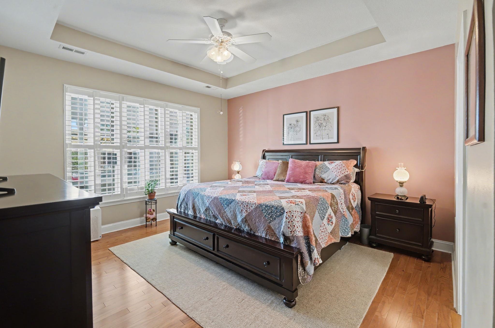 629 Cottontail Trail Myrtle Beach, SC 29588 - Photo 18 of 40 Bedroom featuring a tray ceiling, light wood-type flooring, and ceiling fan