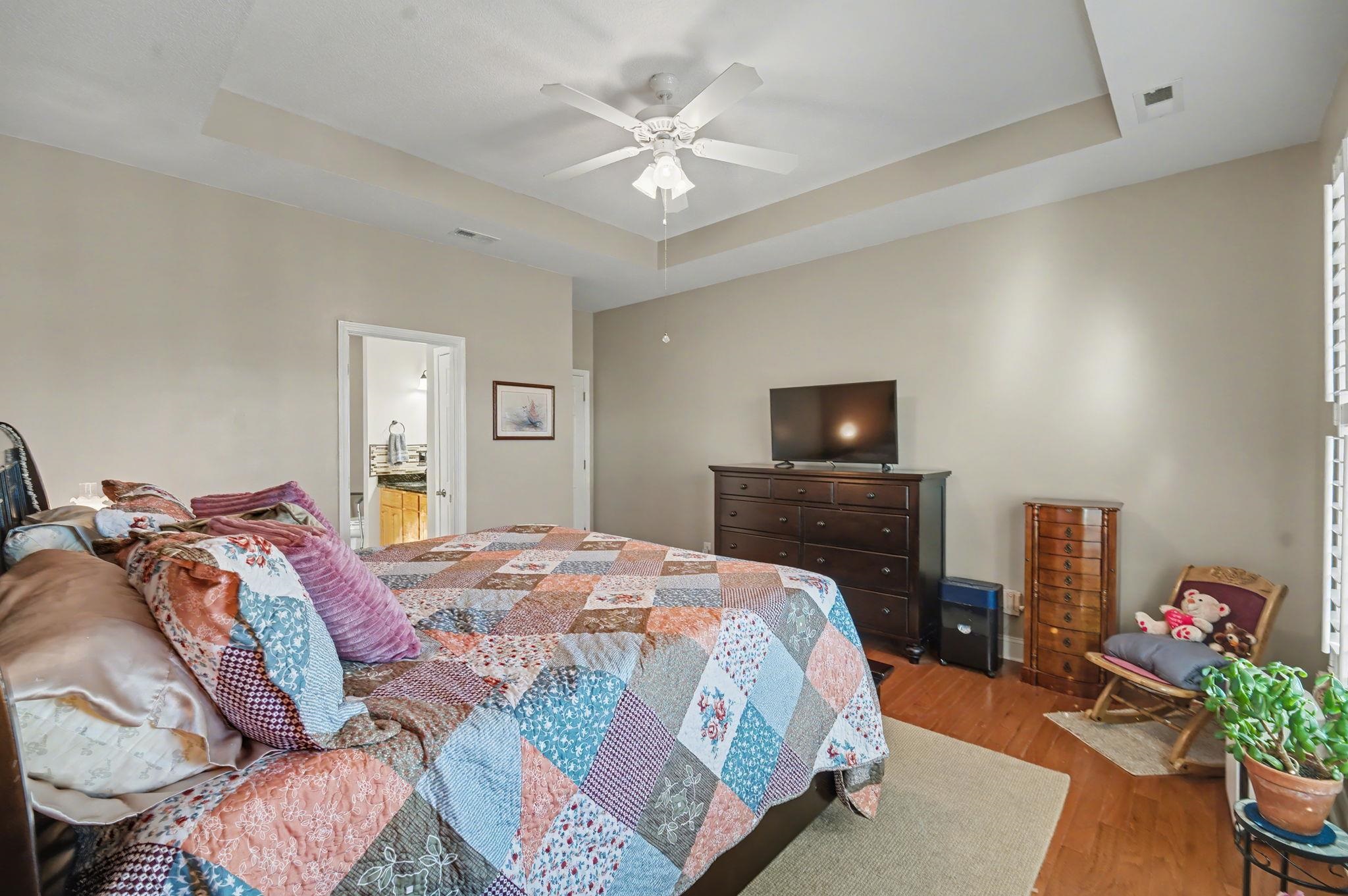 629 Cottontail Trail Myrtle Beach, SC 29588 - Photo 19 of 40 Bedroom featuring a tray ceiling, wood finished floors, and a ceiling fan