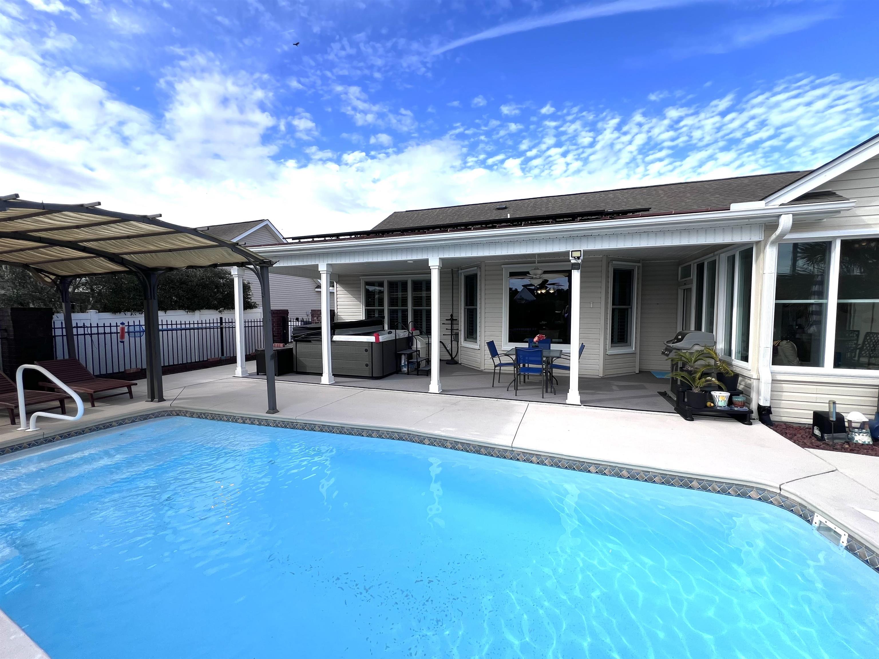 629 Cottontail Trail Myrtle Beach, SC 29588 - Photo 36 of 40 View of swimming pool featuring a hot tub, a patio, and a pergola