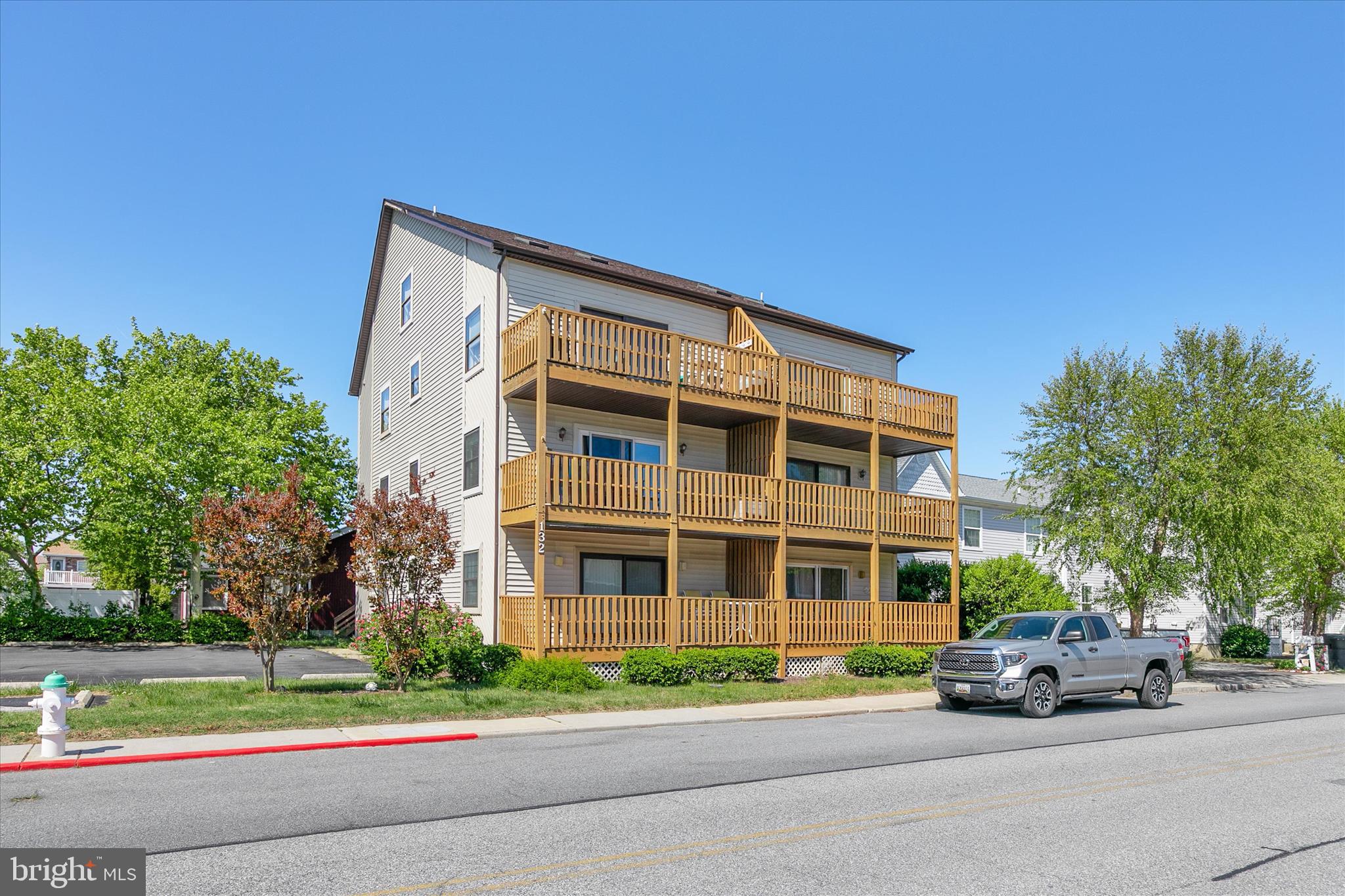 132 Jamestown Road, Unit 601 Ocean City, MD 21842 - Photo 1 of 37 a front view of a house with a yard