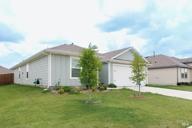 a front view of house with yard and green space