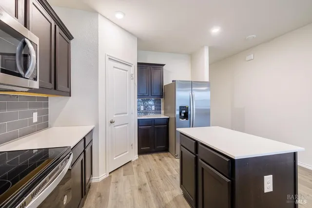 a kitchen with a stove refrigerator and a sink