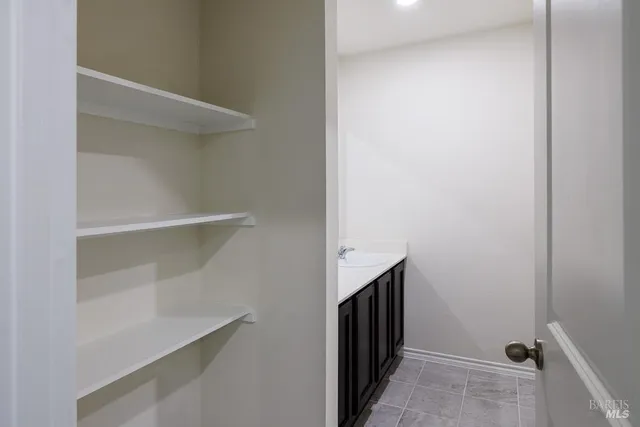a view of walk in closet with empty racks