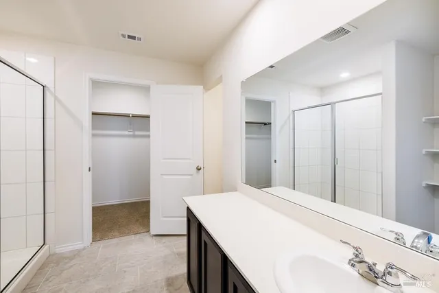a spacious bathroom with a shower and a sink