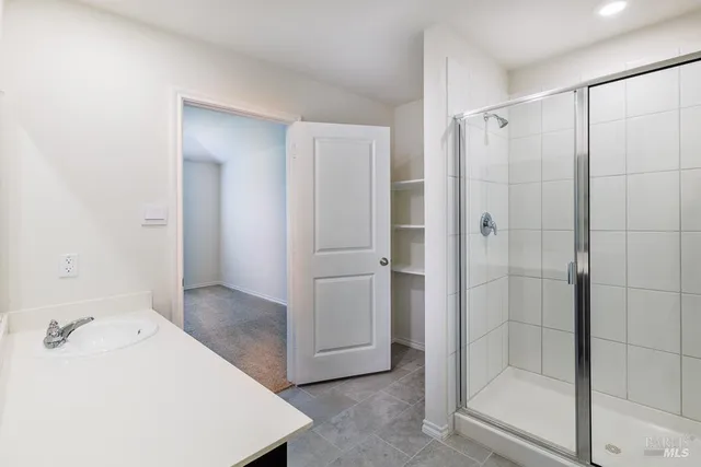 a bathroom with a shower and a sink