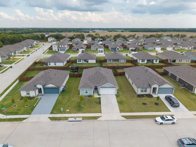an aerial view of residential houses with outdoor space