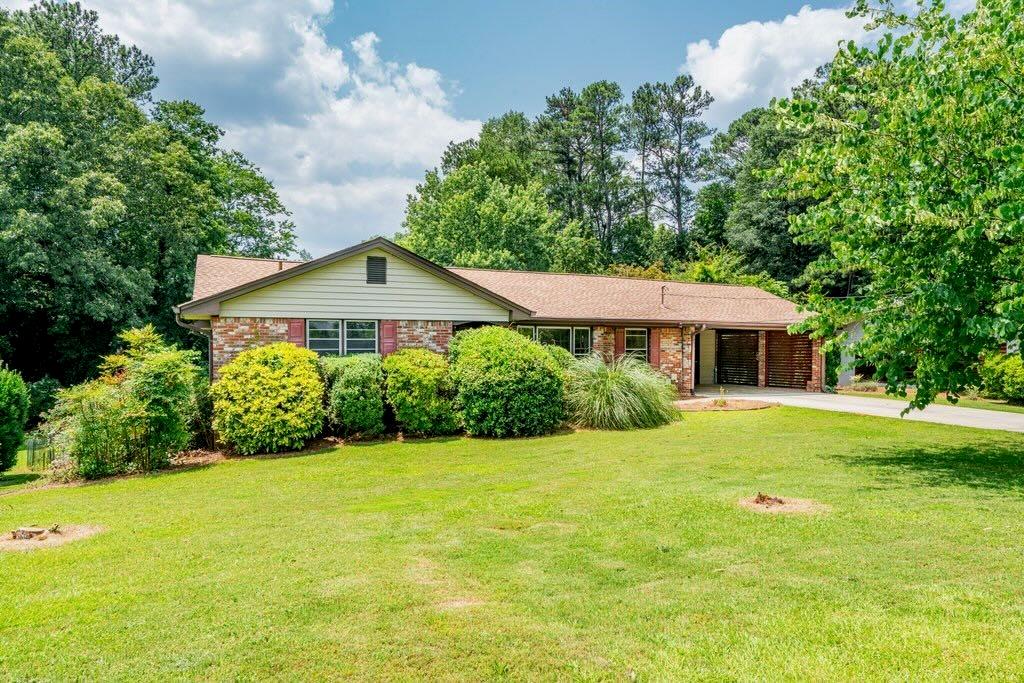 3854 Ridgewood Drive Southeast Smyrna, GA 30080 - Photo 2 of 40 a front view of a house with yard and green space