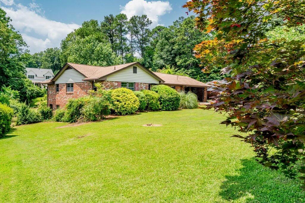 3854 Ridgewood Drive Southeast Smyrna, GA 30080 - Photo 3 of 40 a view of a large garden with plants and large trees