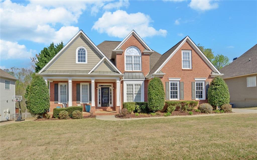 4286 Cami Way Northeast Buford, GA 30519 - Photo 1 of 39 a front view of house with yard and green space