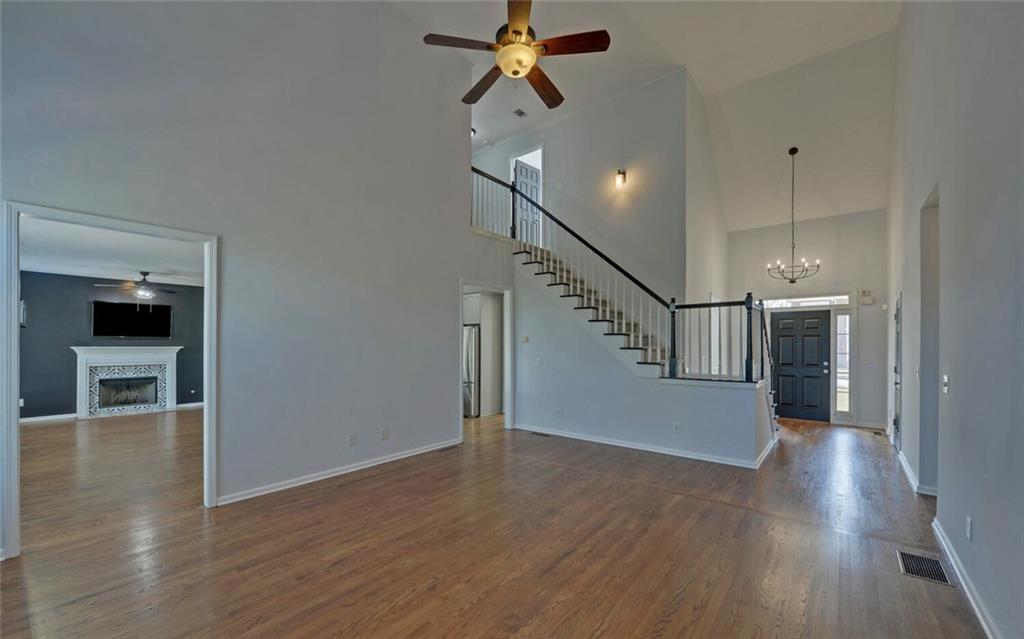 4286 Cami Way Northeast Buford, GA 30519 - Photo 14 of 39 a view of a hallway with wooden floor and staircase