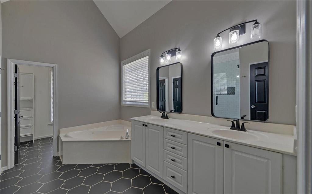 4286 Cami Way Northeast Buford, GA 30519 - Photo 17 of 39 a bathroom with a double vanity sink mirror and bathtub