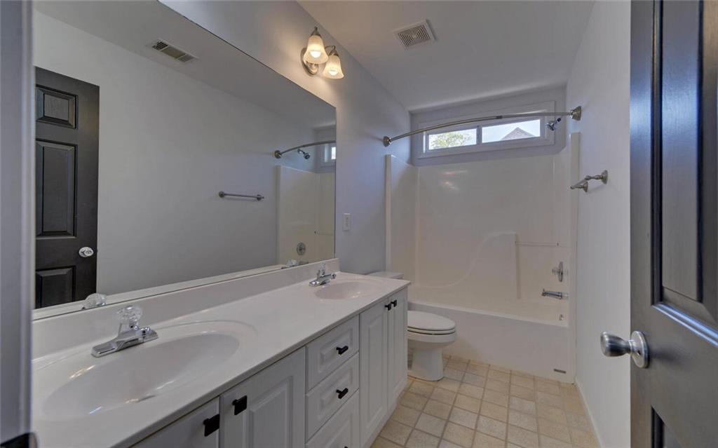 4286 Cami Way Northeast Buford, GA 30519 - Photo 24 of 39 a bathroom with a double vanity sink toilet and shower
