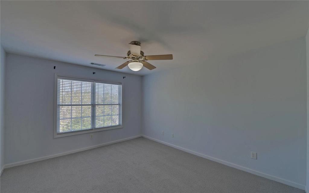 4286 Cami Way Northeast Buford, GA 30519 - Photo 25 of 39 an empty room with windows and fan