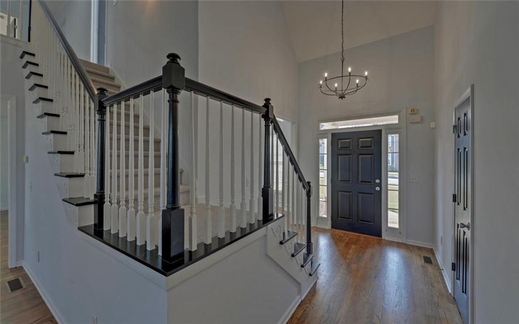 4286 Cami Way Northeast Buford, GA 30519 - Photo 5 of 39 a view of a hallway with wooden floor and staircase