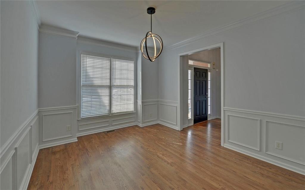4286 Cami Way Northeast Buford, GA 30519 - Photo 6 of 39 a view of empty room with wooden floor and fan