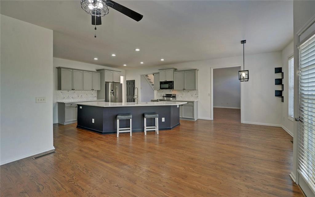 4286 Cami Way Northeast Buford, GA 30519 - Photo 9 of 39 a kitchen with kitchen island a cabinets and wooden floor
