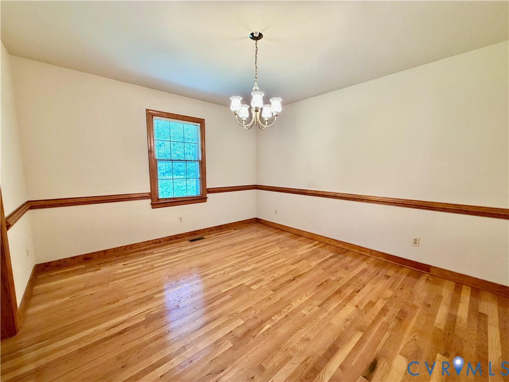 3933 Dunraven Road North Chesterfield, VA 23236 - Photo 17 of 30 wooden floor in an empty room with a window