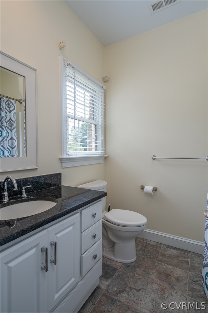 209 Castlerock Williamsburg, VA 23188 - Photo 24 of 31 a bathroom with a granite countertop sink a toilet and a window