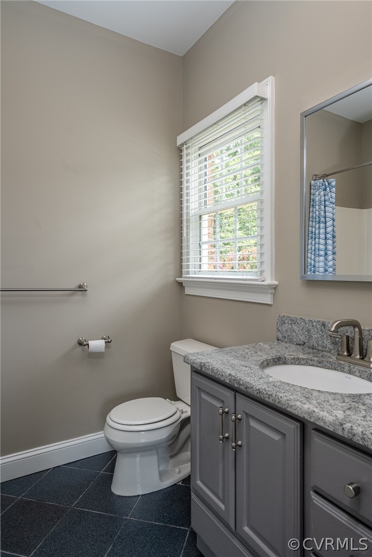 209 Castlerock Williamsburg, VA 23188 - Photo 25 of 31 a bathroom with a granite countertop toilet a sink and a window