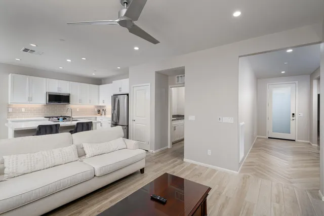 a living room with furniture and kitchen view