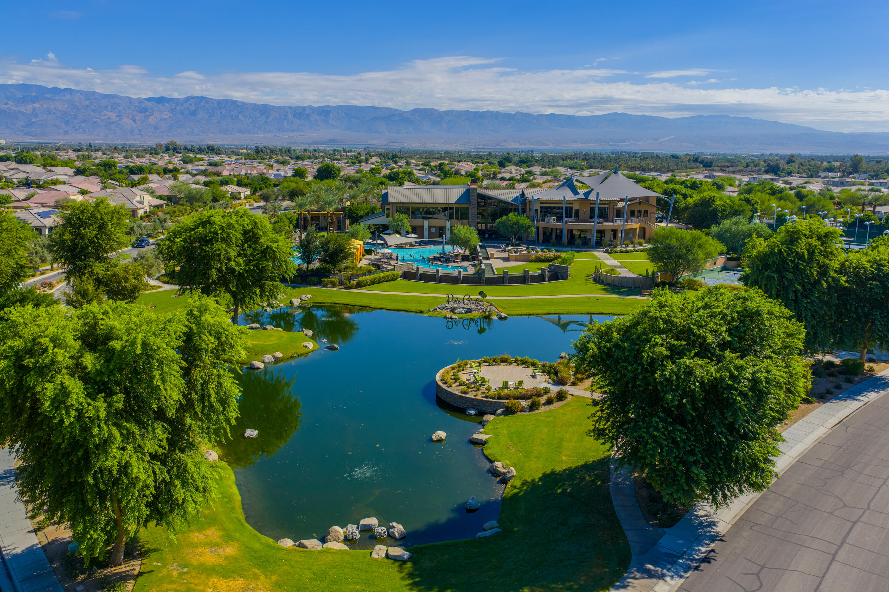 50380 Timber Creek Way Indio, CA 92201 - Photo 37 of 50 a view of a swimming pool with a garden and trees