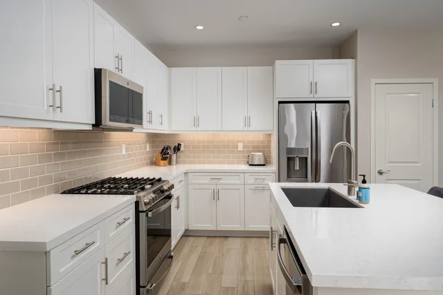 a kitchen with a sink a stove and refrigerator