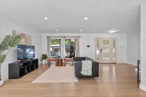 a living room with furniture window and flat screen tv