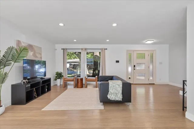 a living room with furniture window and flat screen tv
