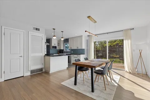 a view of a dining room with furniture window and wooden floor