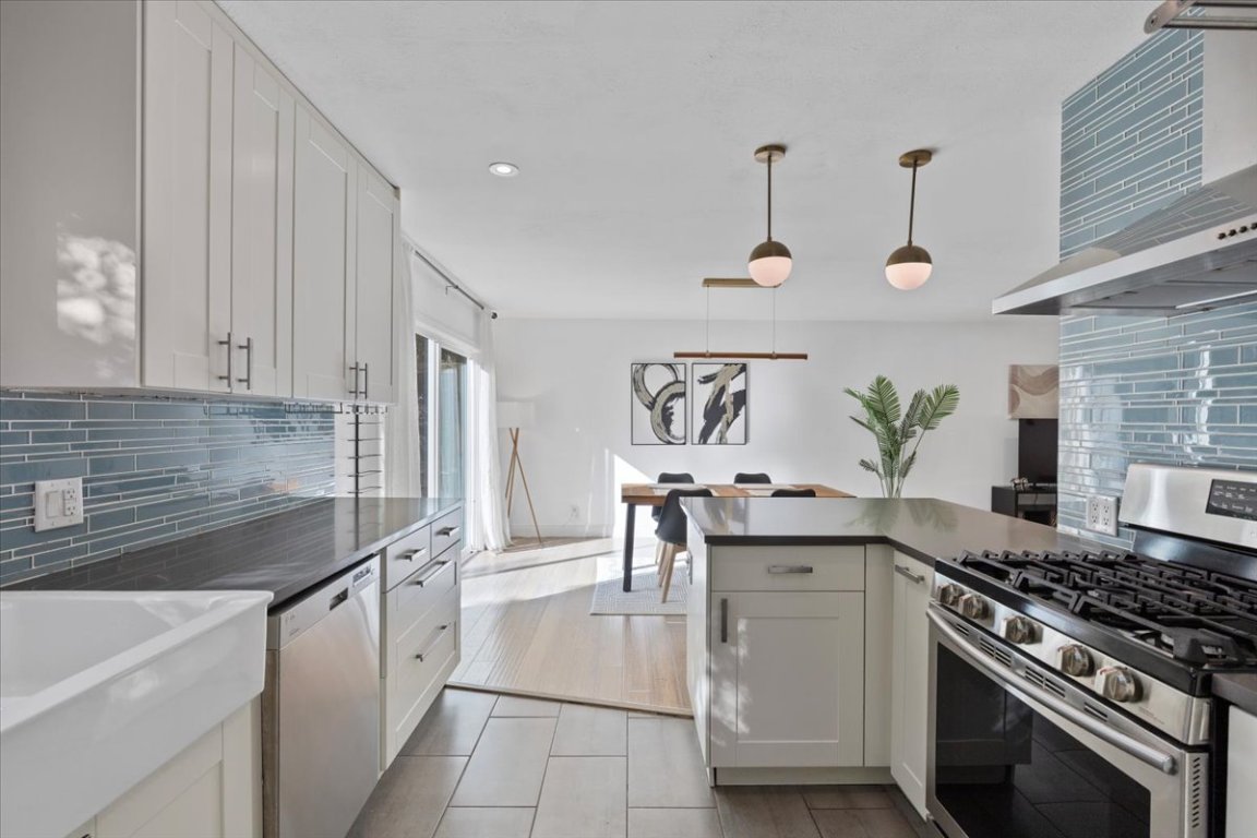 5313 Harvest Lane Austin, TX 78745 - Photo 12 of 28 a kitchen with stainless steel appliances granite countertop a sink stove and cabinets