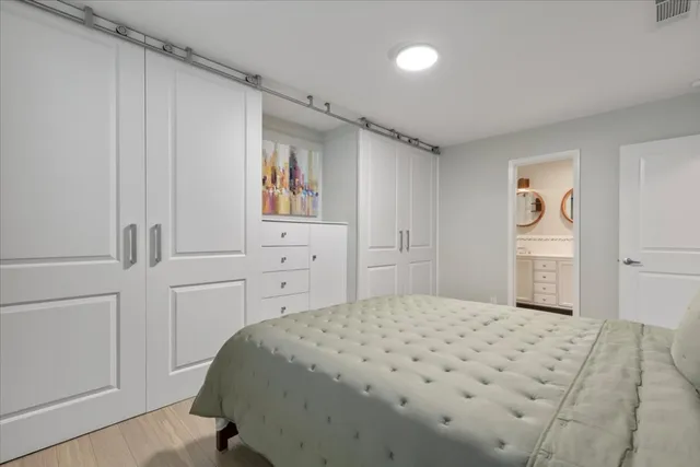a bedroom with a bed and a cabinets