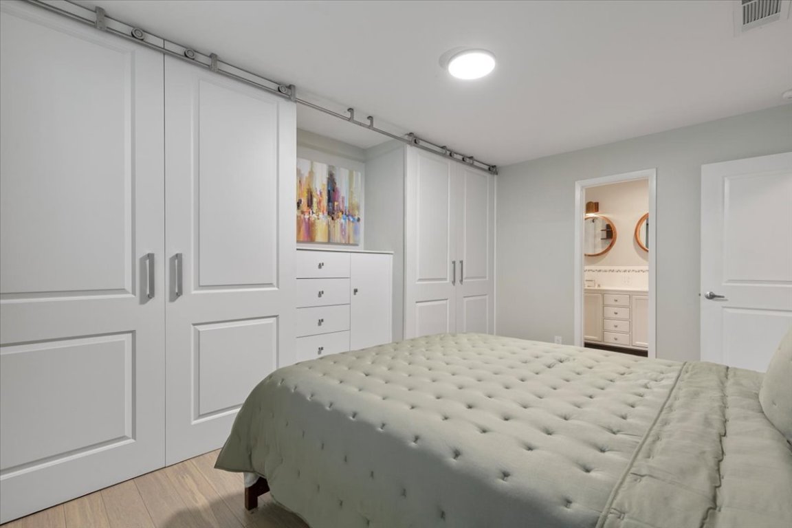 5313 Harvest Lane Austin, TX 78745 - Photo 18 of 28 a bedroom with a bed and a cabinets