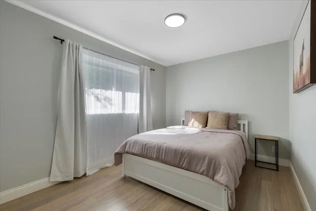 a bedroom with a bed and a window