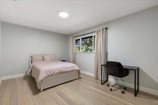 a bedroom with a bed and a chair