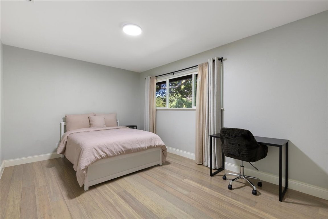 5313 Harvest Lane Austin, TX 78745 - Photo 21 of 28 a bedroom with a bed and a chair