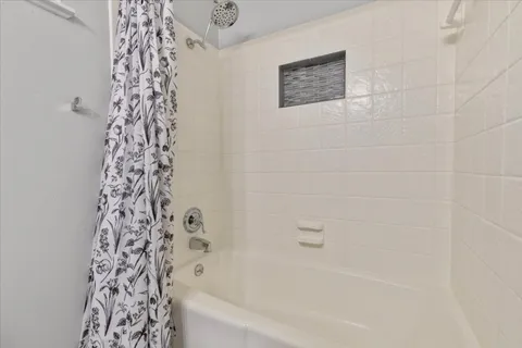 a bathroom with a bathtub and shower