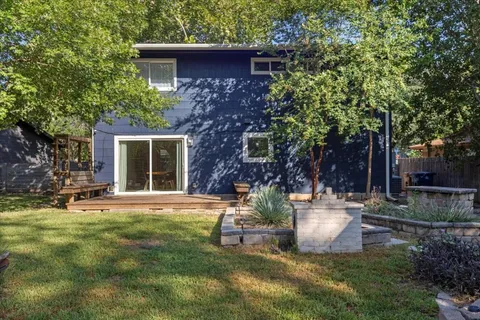 a view of a house with backyard and sitting area