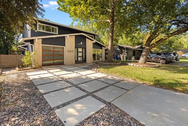 a view of a yard with a house and a tree