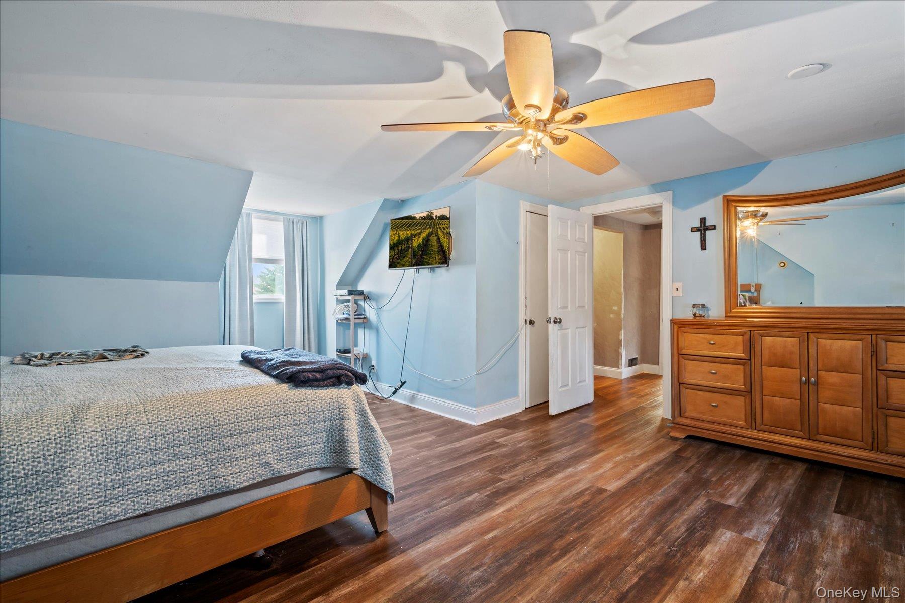 280 Moriches Road St. James, NY 11780 - Photo 14 of 39 a bedroom with a bed and a chandelier