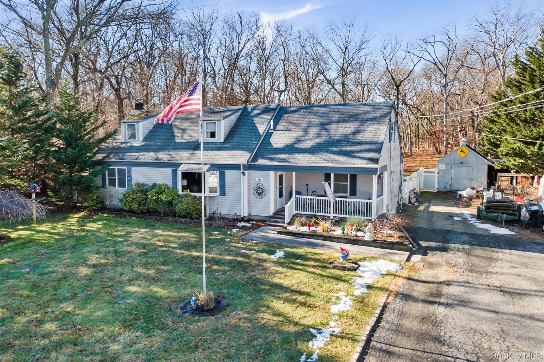 280 Moriches Road St. James, NY 11780 - Photo 2 of 39 a house view with a sitting space and garden space