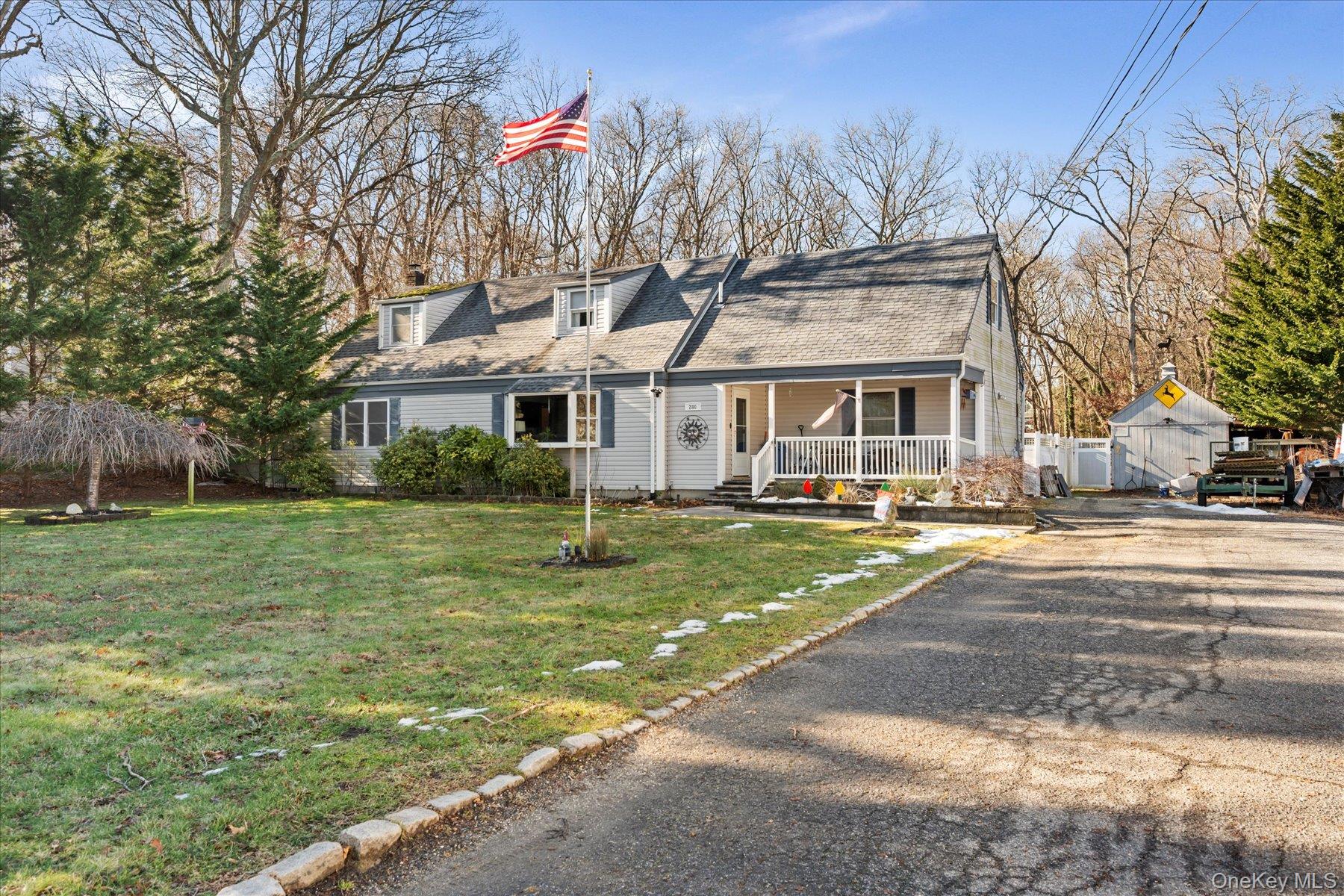 280 Moriches Road St. James, NY 11780 - Photo 28 of 39 a front view of a house with a yard table and chairs