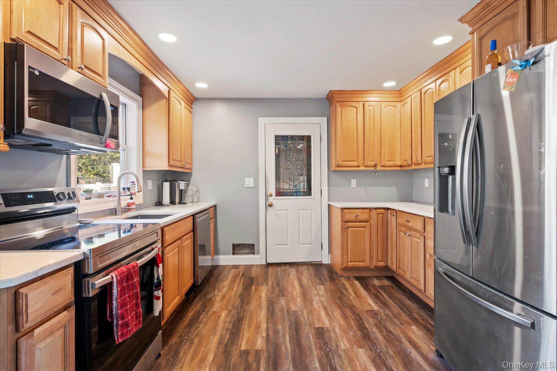 280 Moriches Road St. James, NY 11780 - Photo 8 of 39 a kitchen with stainless steel appliances granite countertop a refrigerator a stove top oven a sink and dishwasher