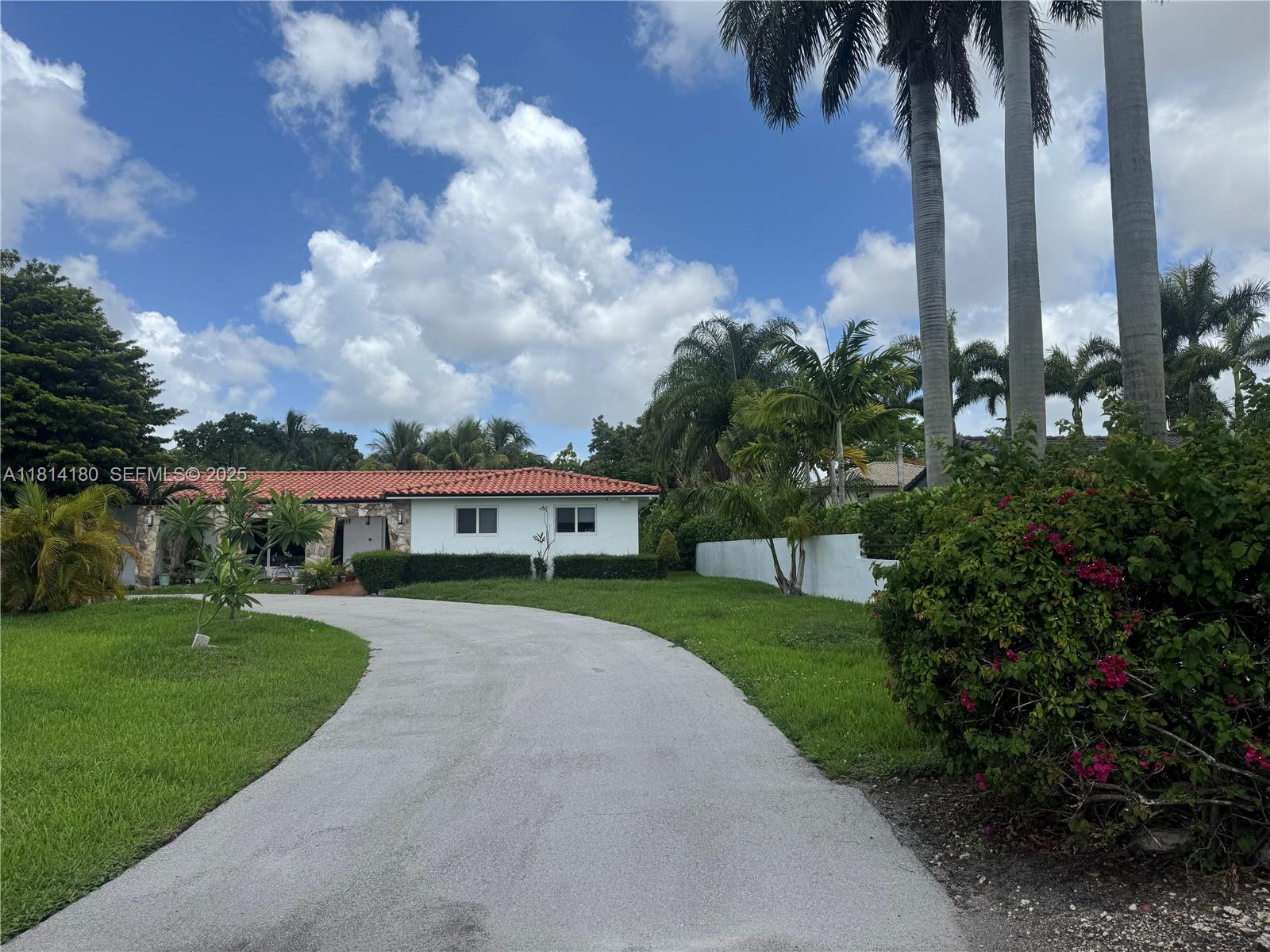 220 Northwest 130th Avenue Miami, FL 33182 - Photo 1 of 32 a view of a house with a big yard and palm trees