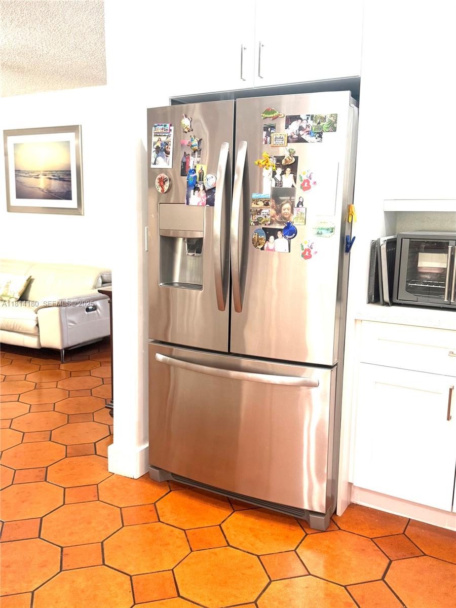 220 Northwest 130th Avenue Miami, FL 33182 - Photo 12 of 32 a white refrigerator freezer sitting in a kitchen
