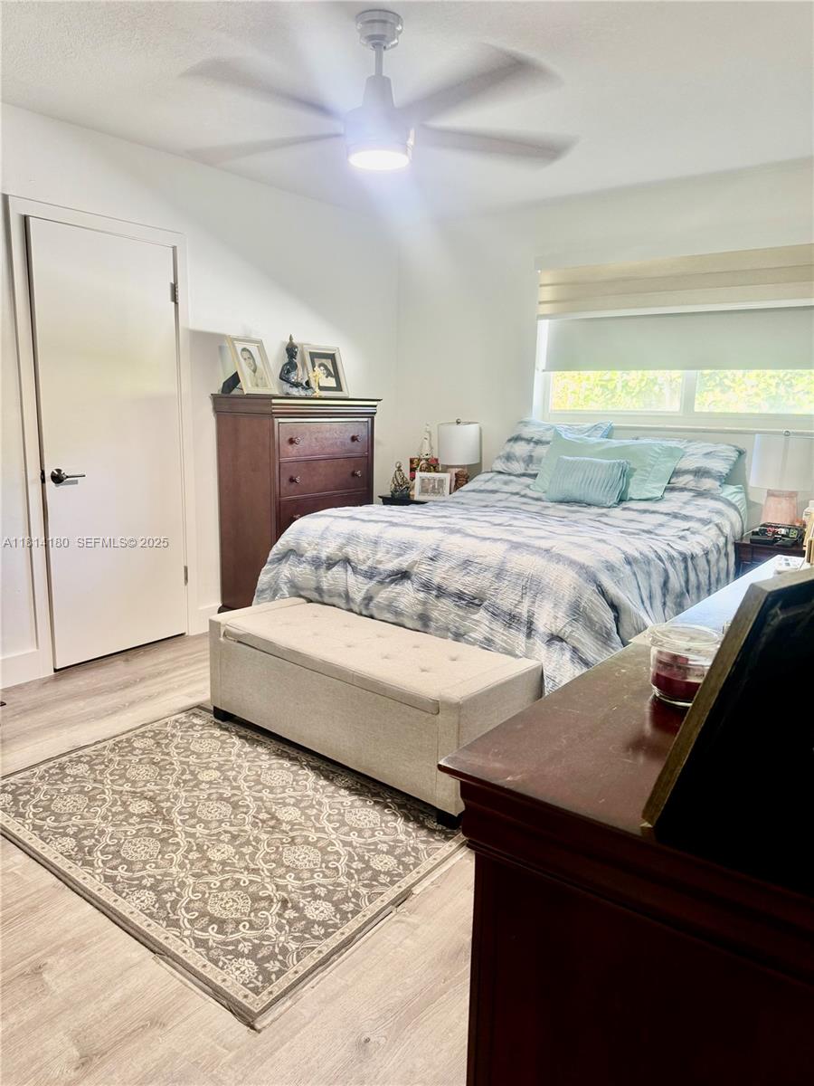 220 Northwest 130th Avenue Miami, FL 33182 - Photo 13 of 32 a living room with a bed and a dresser